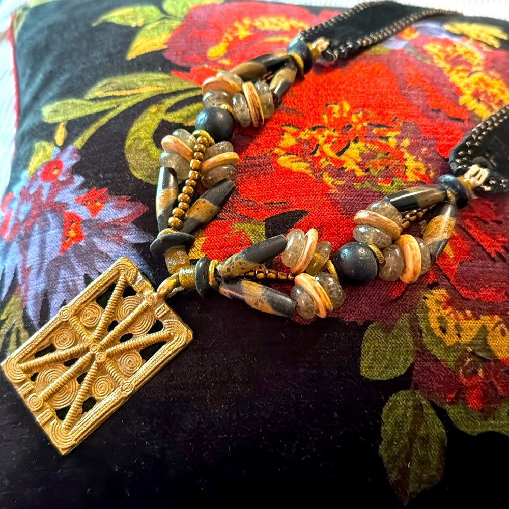 Twine & Twig mid length black with gold tone metal pendant.